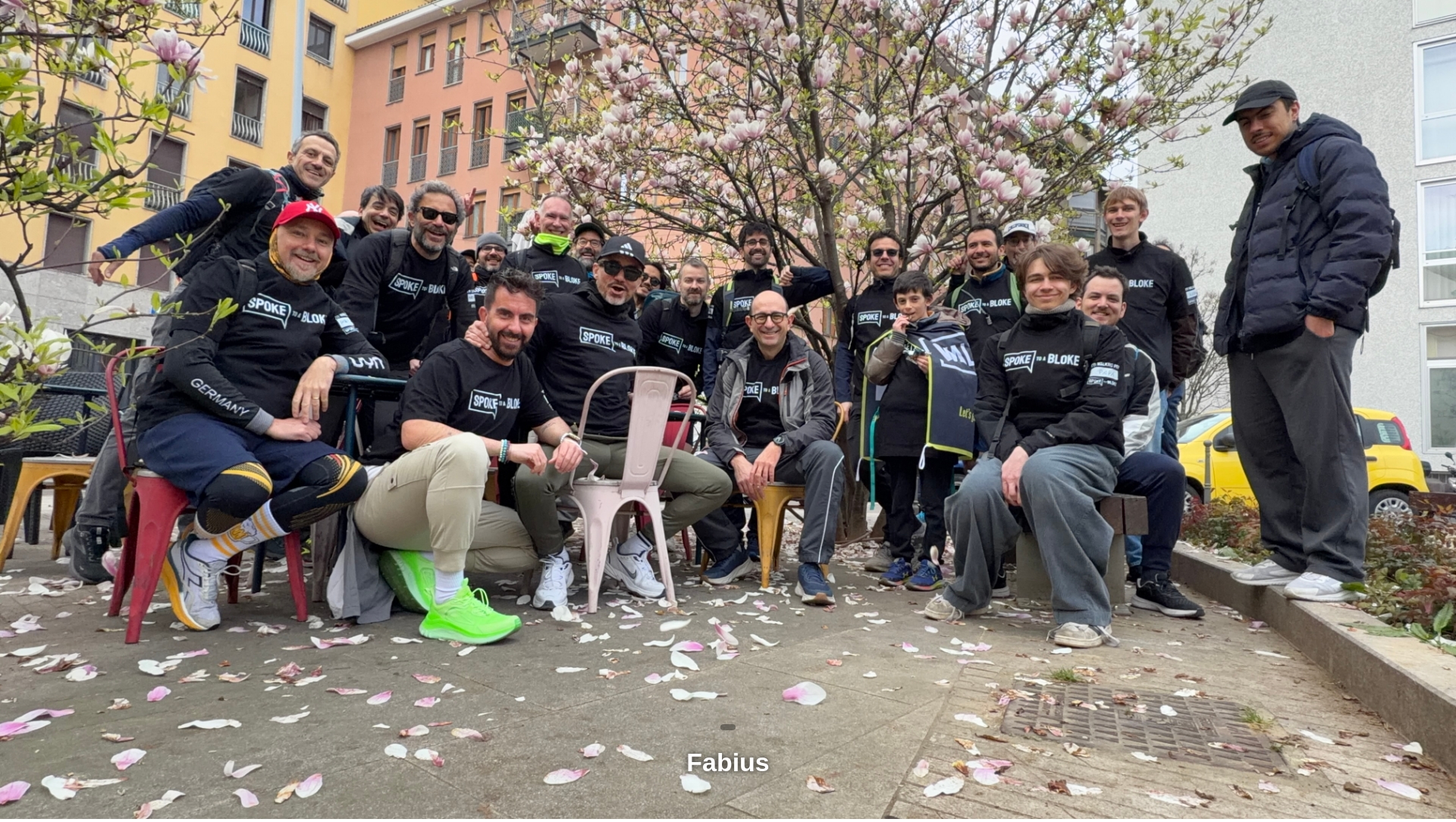 The Milan group gathered under a blossoming magnolia tree