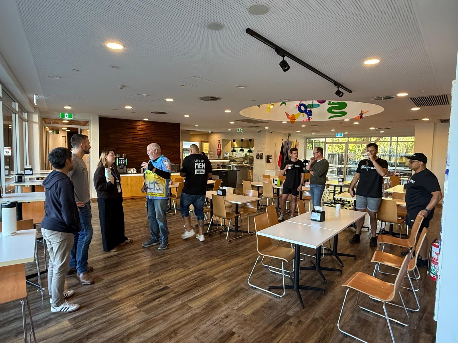 Blokes chatting over a cuppa in the Ronald McDonald House dining room