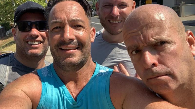 Four blokes running selfie on a sunny day