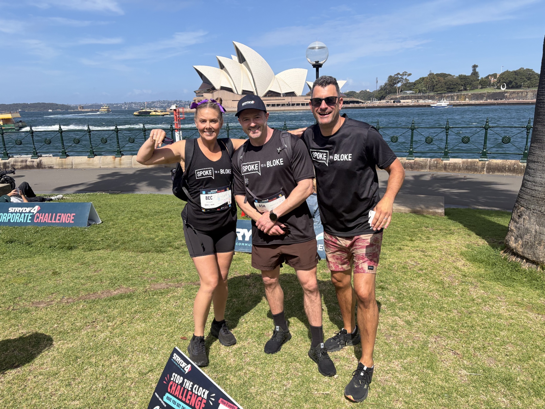 Three participants beside Sydney Harbour with the Opera House behind them